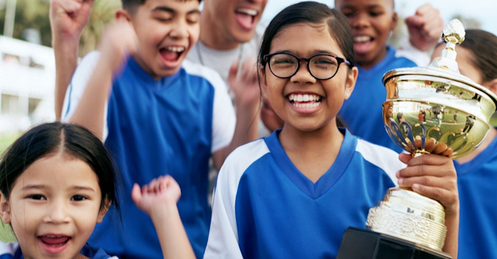 Kids playing sports with trophy