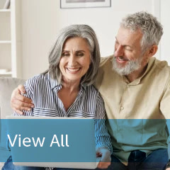 Couple schedule eye exam online happy smiling with banner copy "view all"